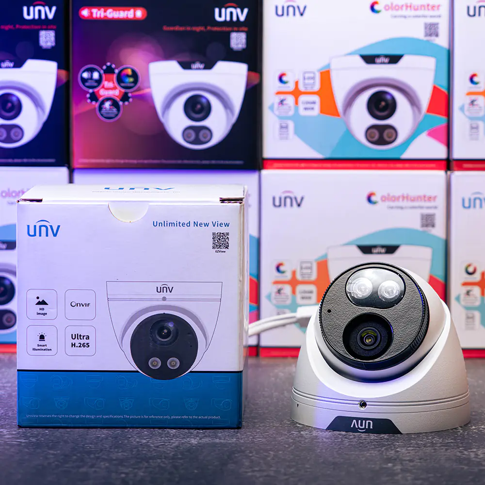 Uniview 4MP dual light turret sitting on a table with the retail box beside it