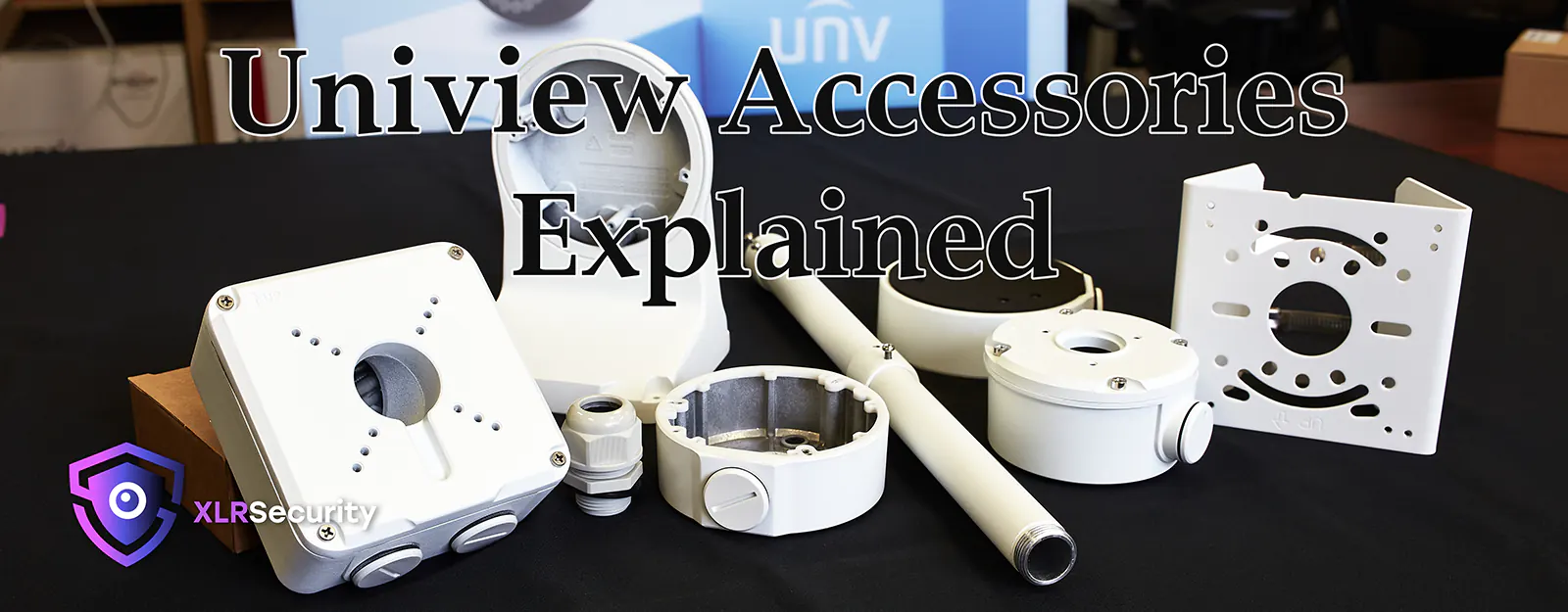 A variety of Uniview camera mounting brackets atop a black table