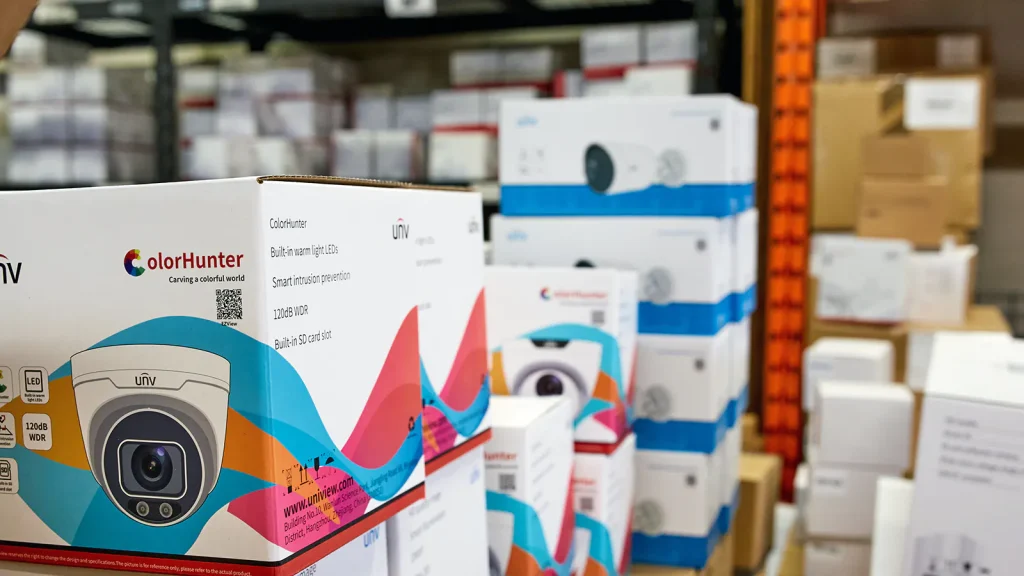 A selection of various Uniview cameras stacked inside of a large warehouse