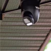 A black Uniview security camera installed into the soffit of a home