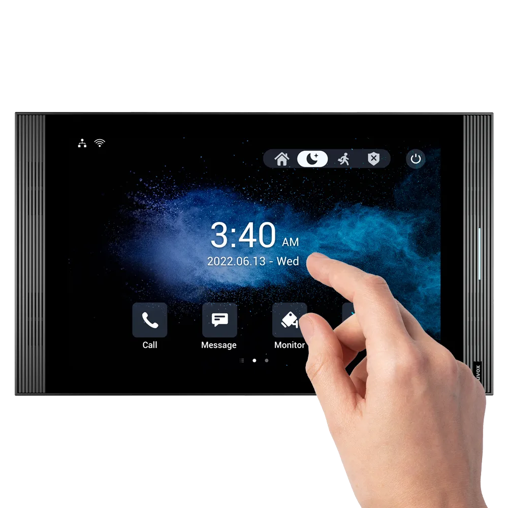 An indoor touchscreen monitor made by Akuvox, with a person's hand tapping the screen.